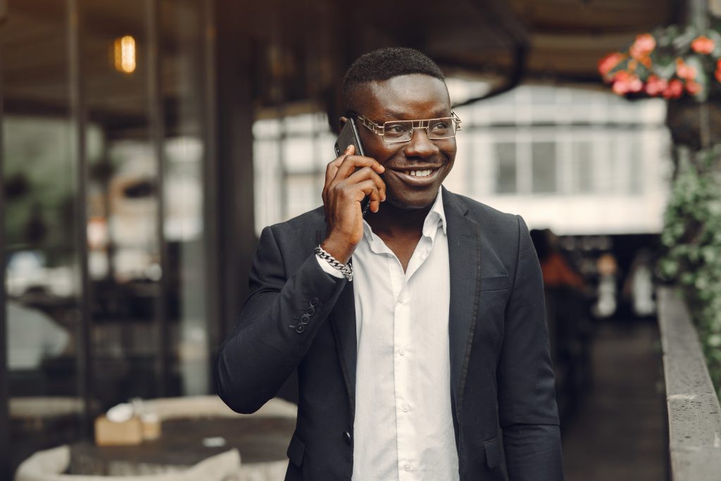 SNS | guy black suit male with mobile phone businessman office