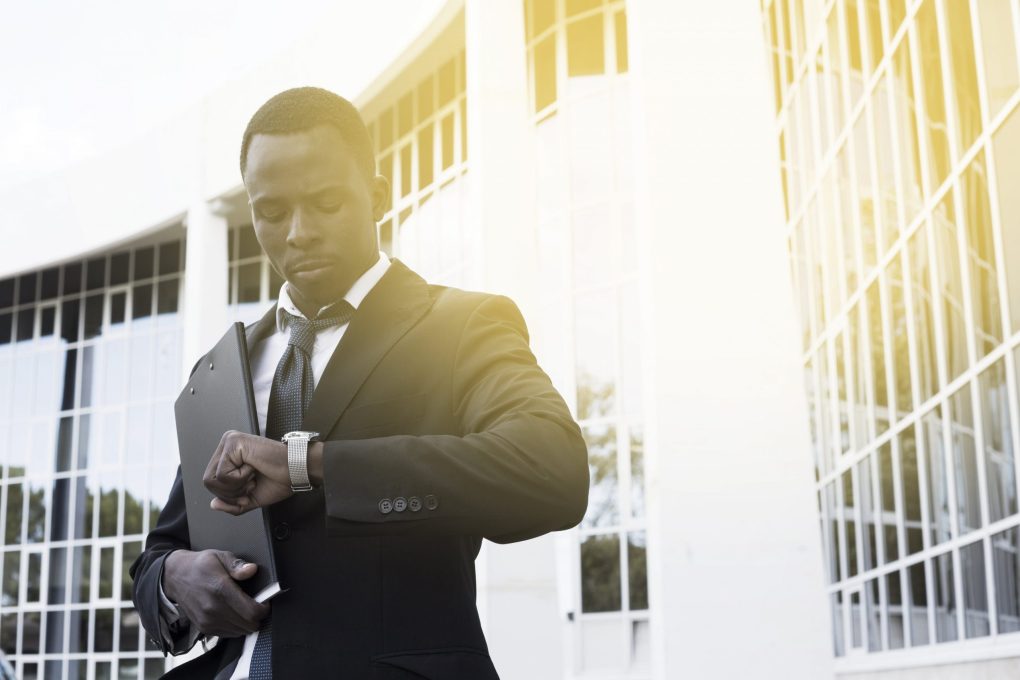 SNS | elegant businessman checking time min scaled